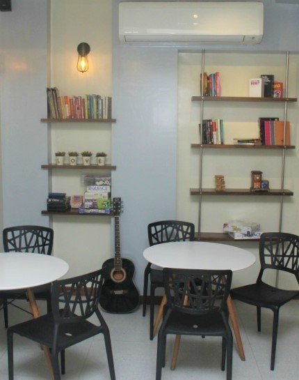 Books, a guitar and inviting tables inside the café